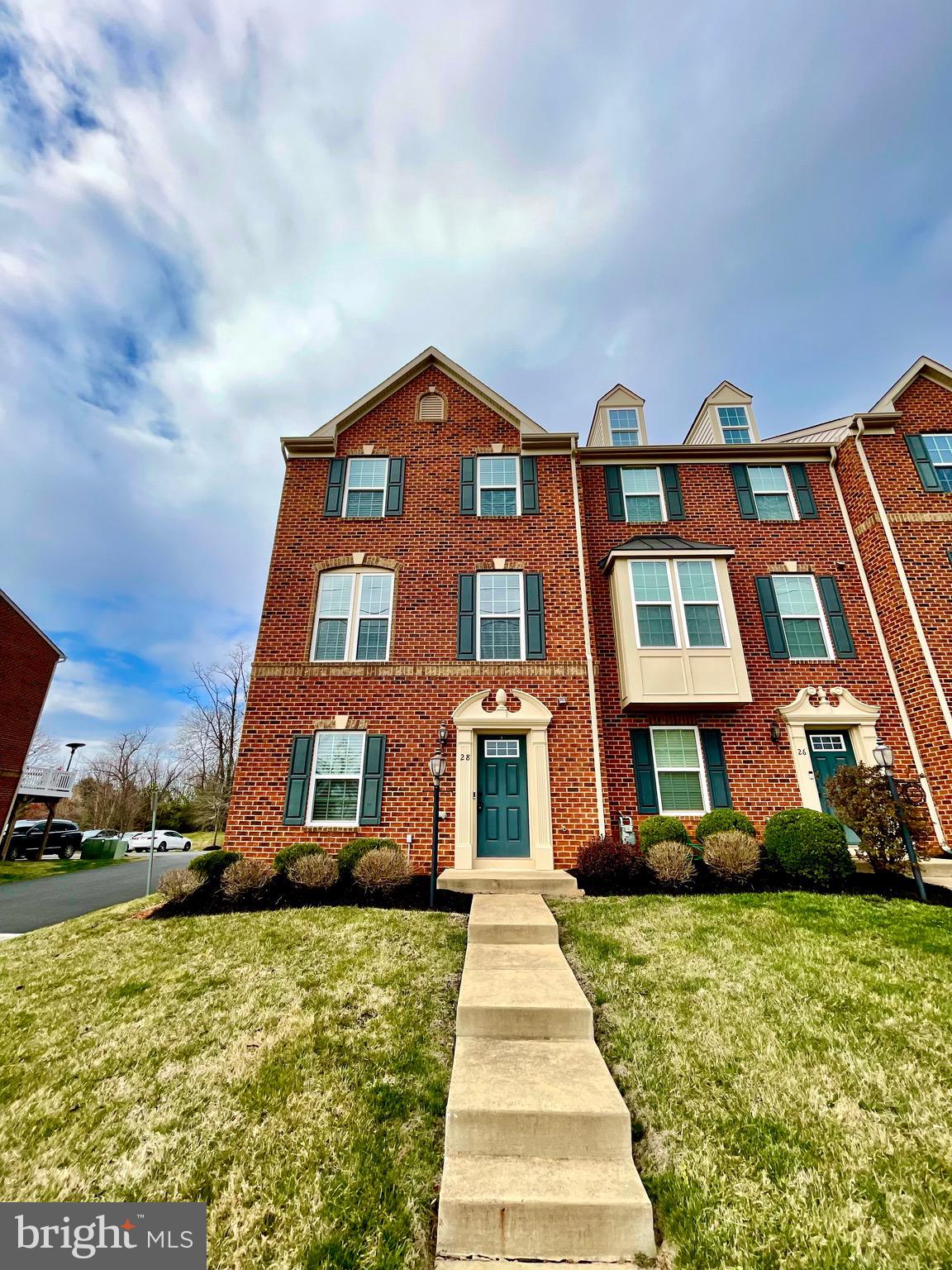 a front view of a residential apartment building with a yard