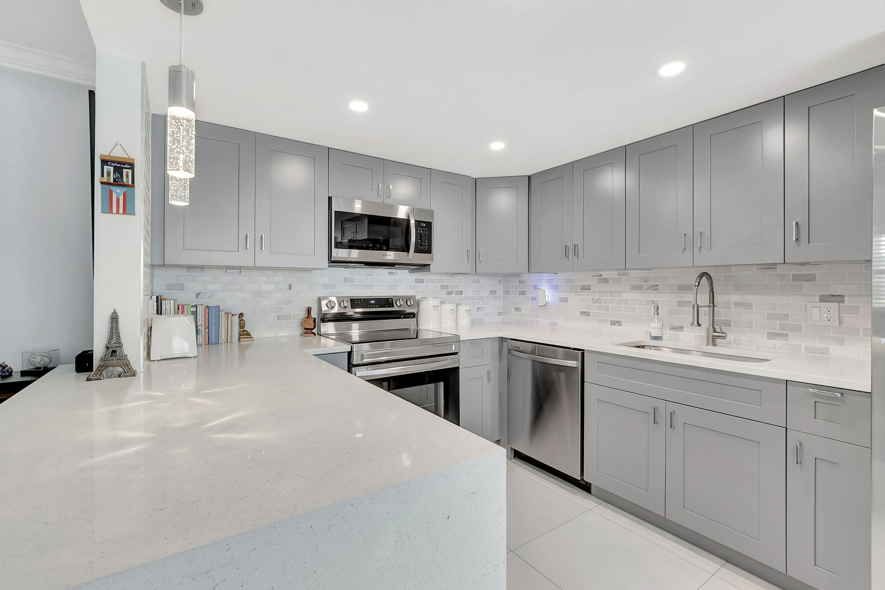 a kitchen with kitchen island a sink stainless steel appliances and cabinets