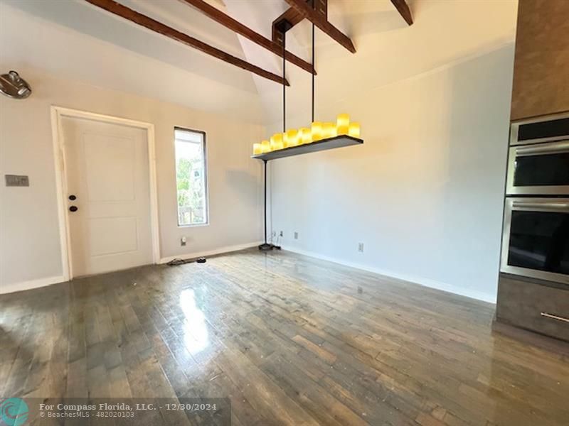 a view of a kitchen with wooden floor