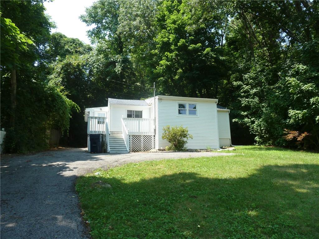 a view of a back yard of the house with green space