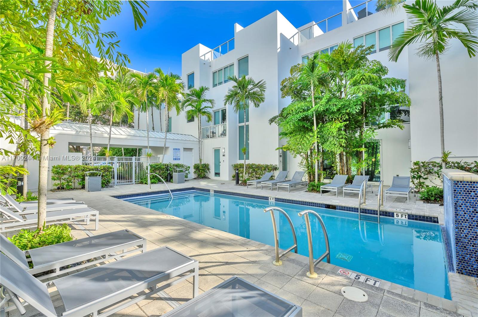 a swimming pool with outdoor seating and yard