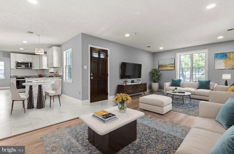 a living room with furniture and a flat screen tv