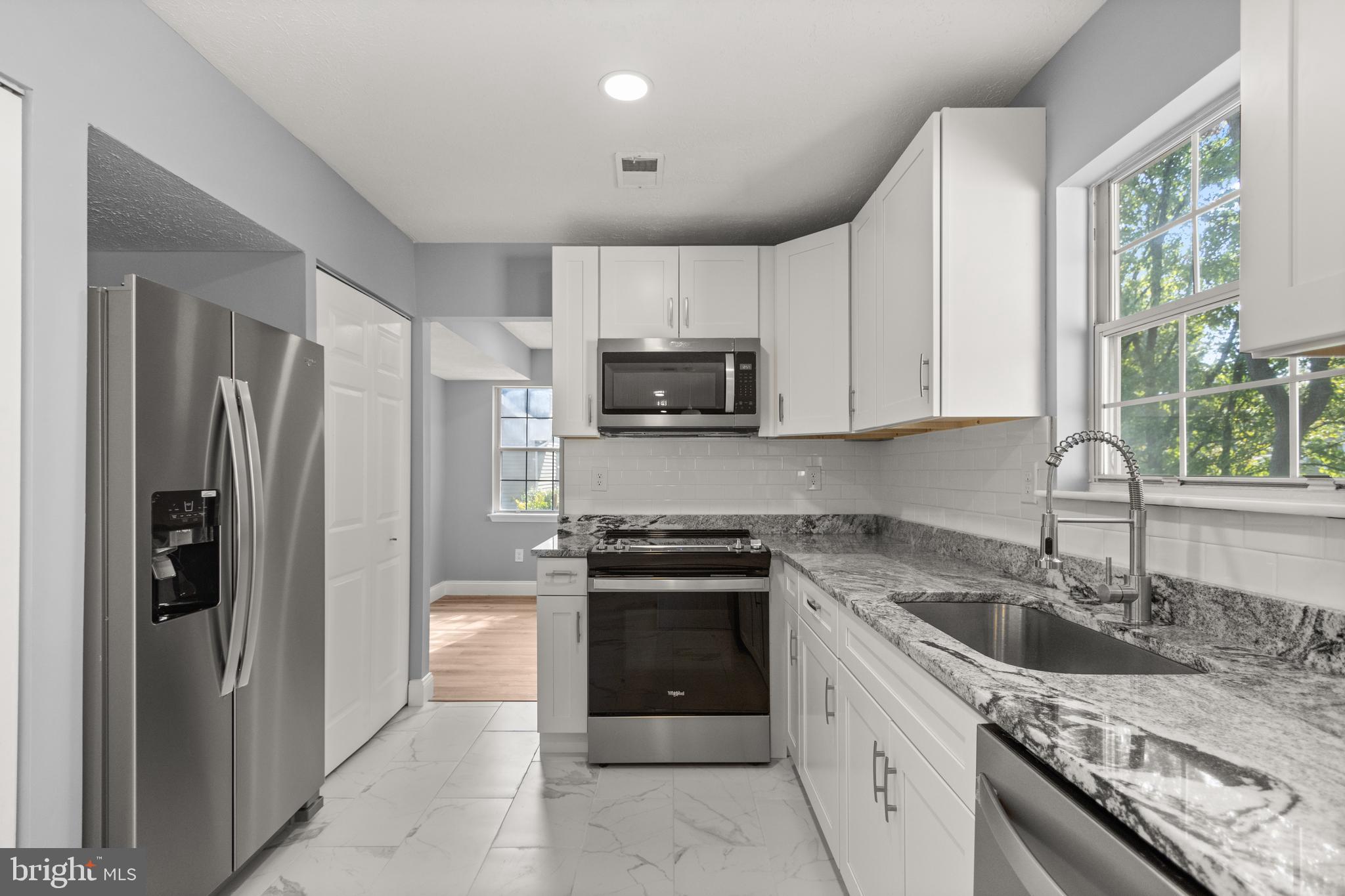 a kitchen with a sink stove and refrigerator