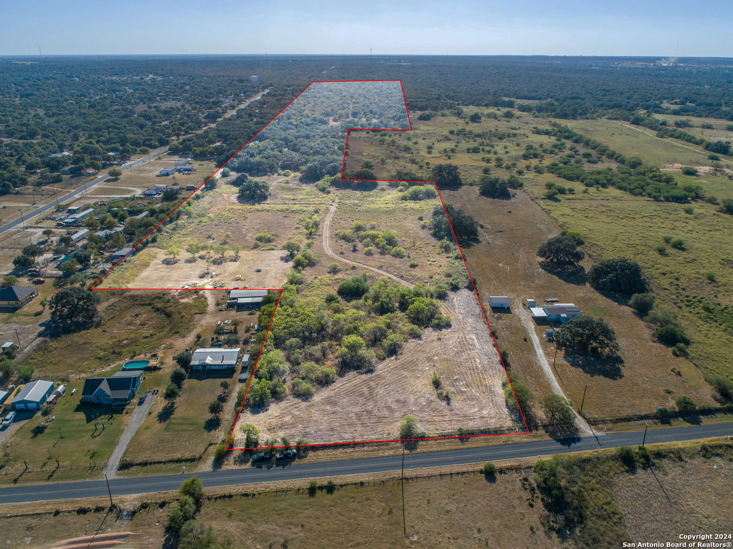 an aerial view of residential houses with outdoor space