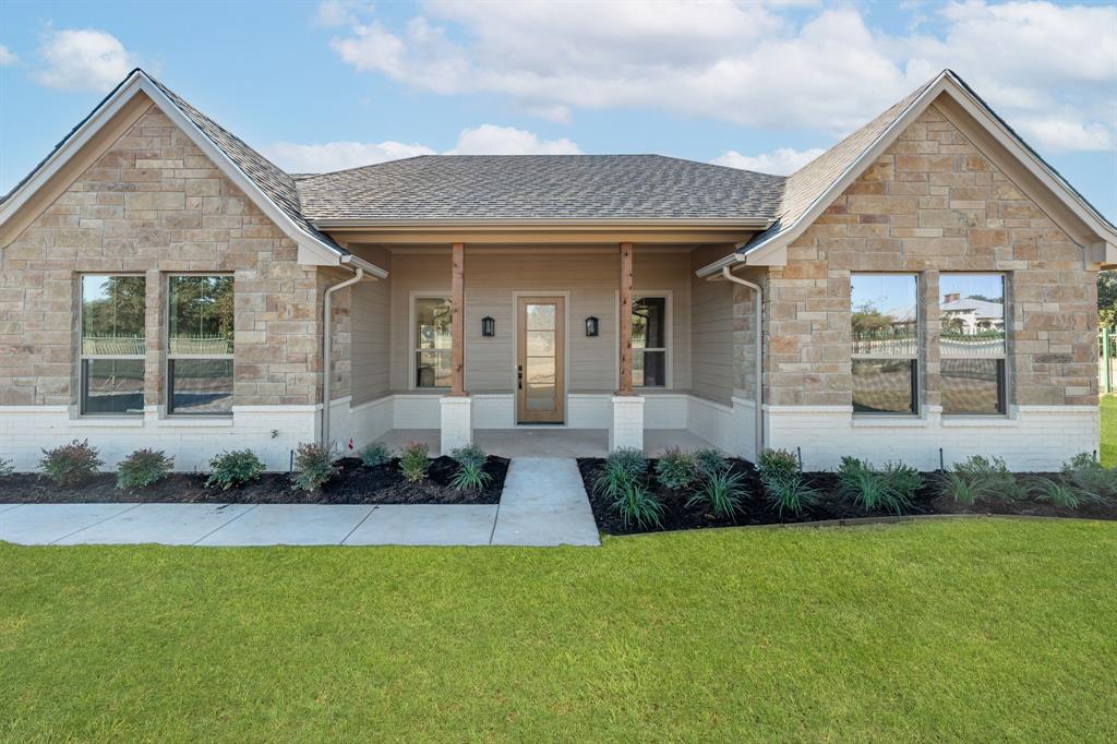 a front view of a house with a yard