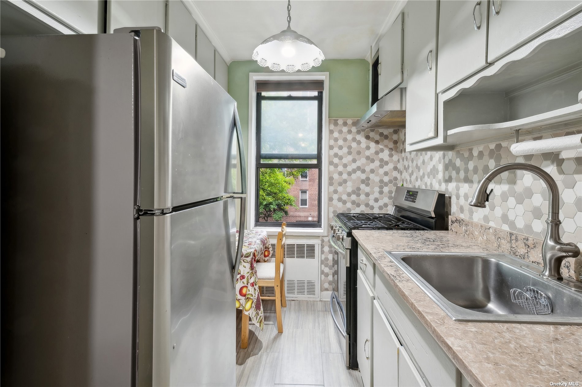 a kitchen with stainless steel appliances granite countertop a refrigerator and a sink