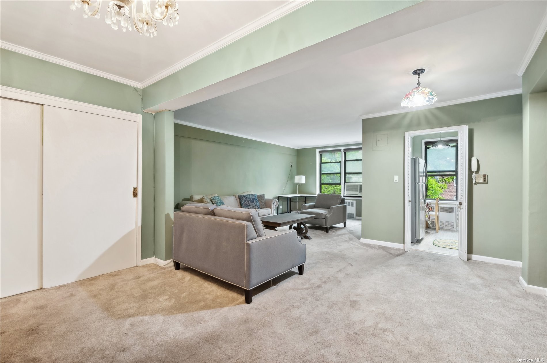 a living room with furniture and a chandelier