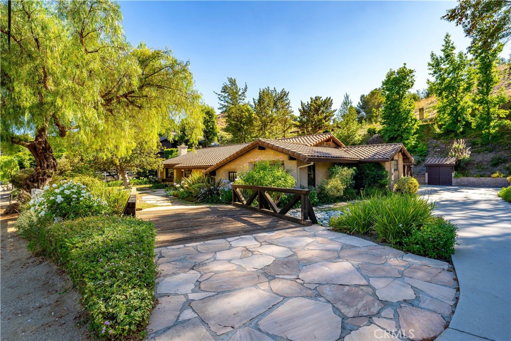 a view of a patio with table and chairs under an umbrella