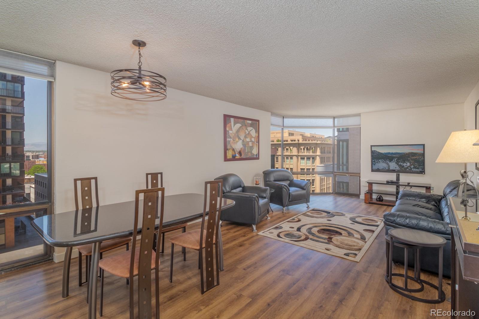 a living room with furniture wooden floor and a table