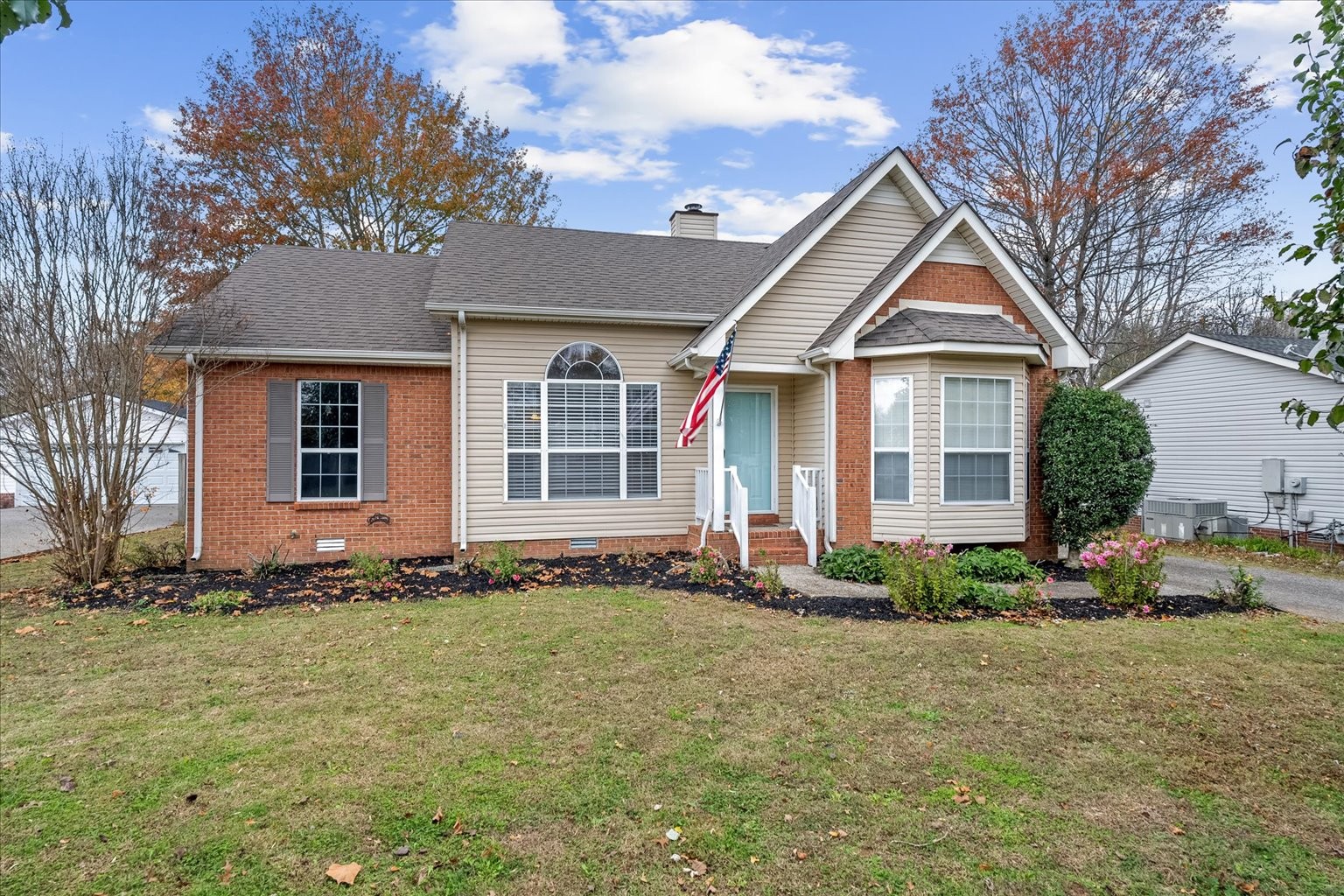 a front view of a house with a garden