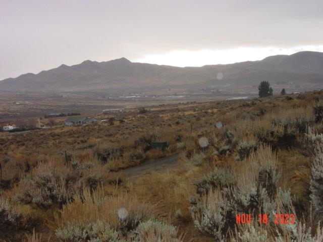 a view of a town with mountains in the background