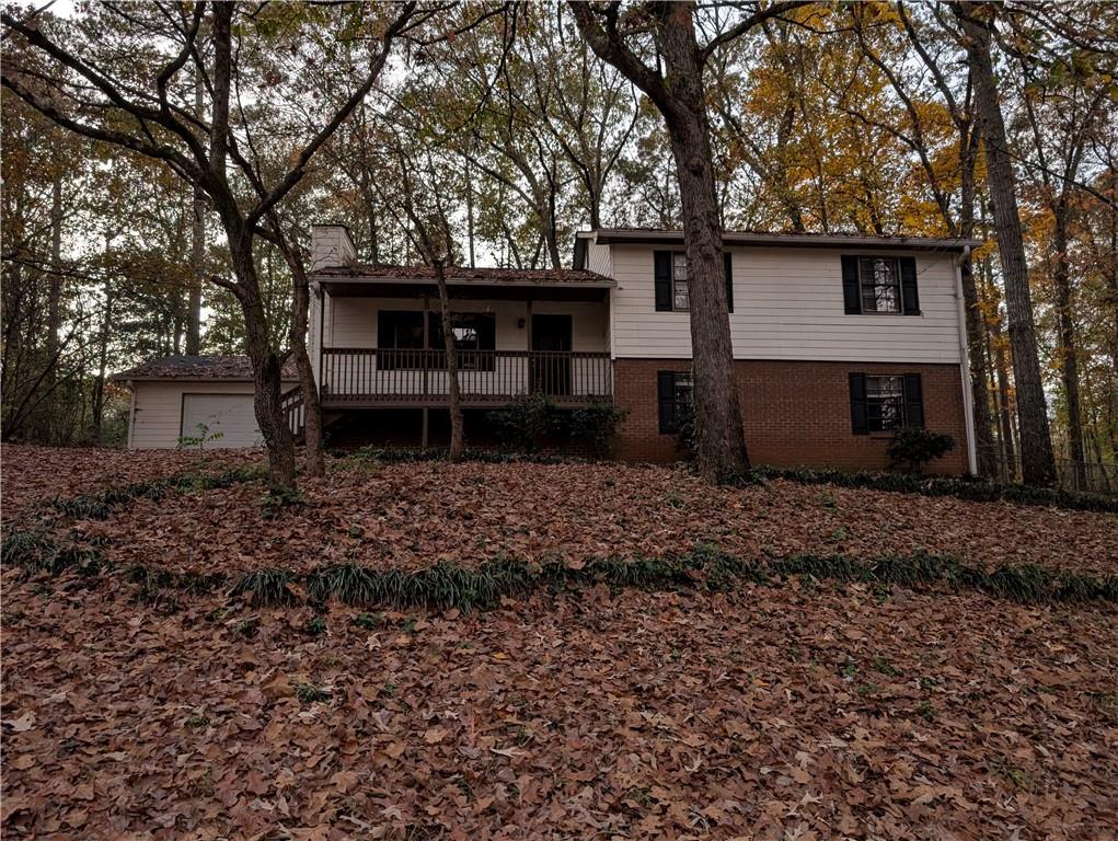 a view of a house with a yard and furniture