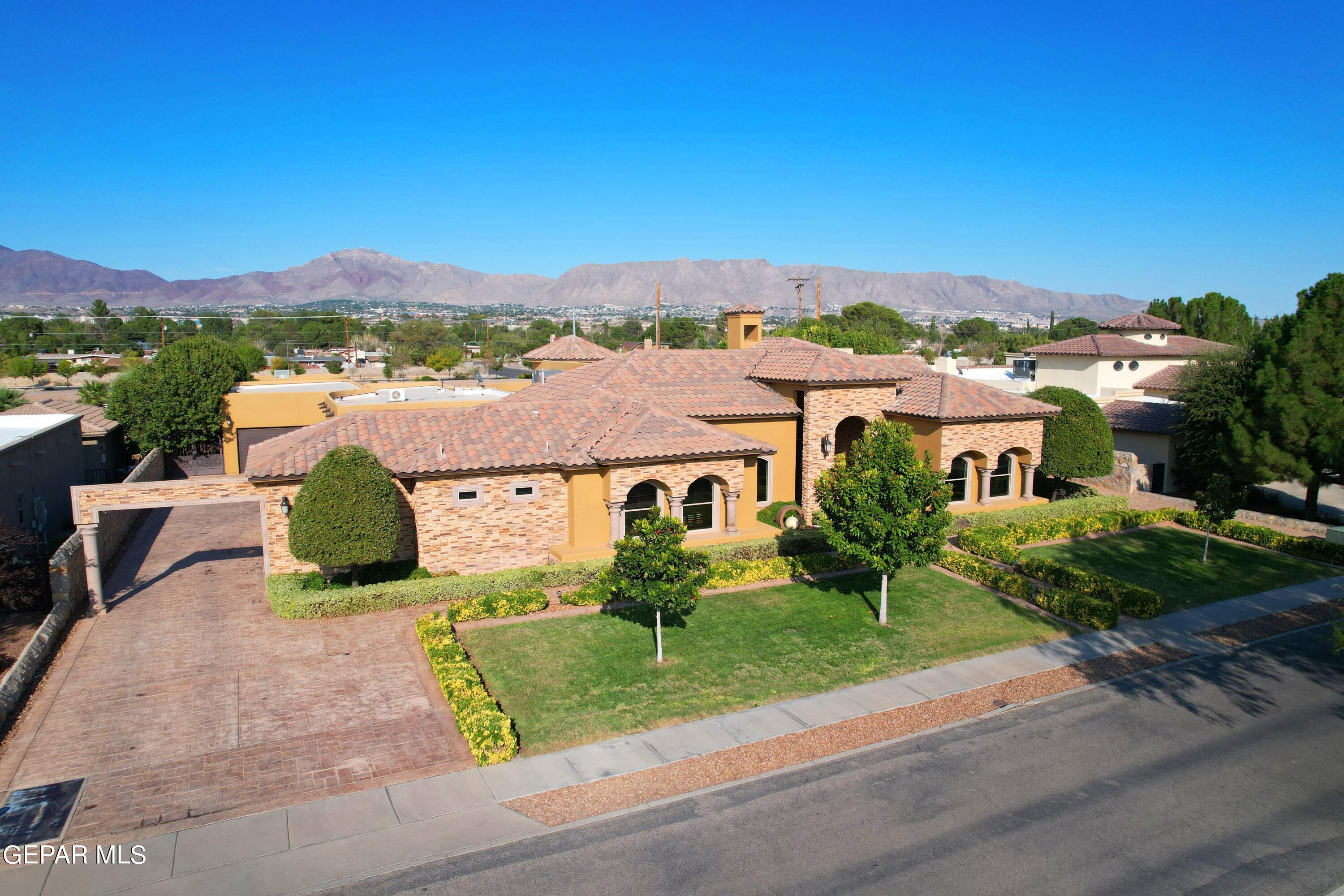 an aerial view of residential houses with outdoor space and street view