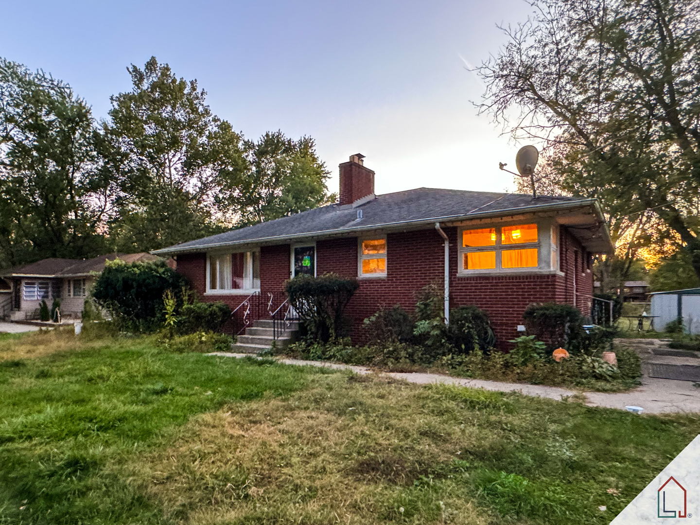 a front view of house with yard and outdoor seating