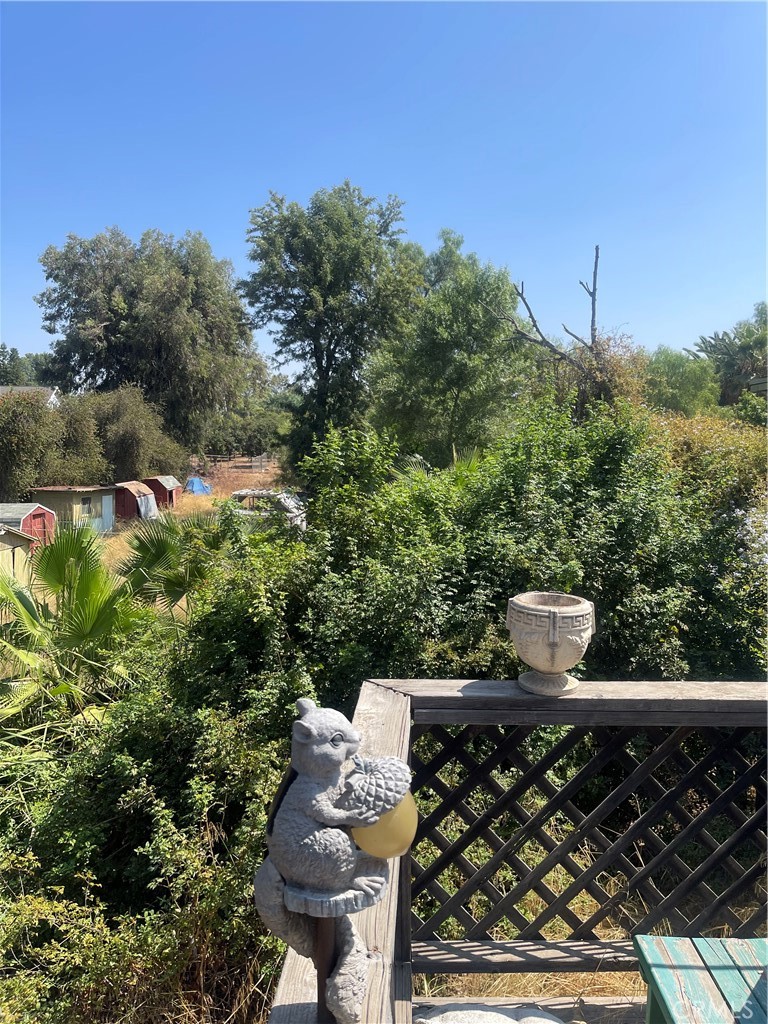 a view of a back yard of the house with green space