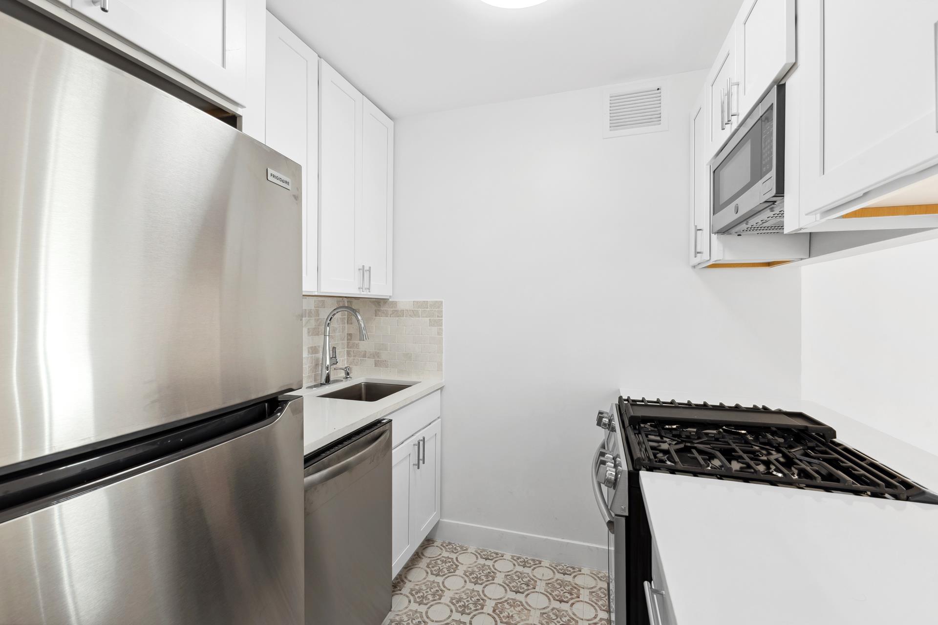 a kitchen with a sink a stove and cabinets