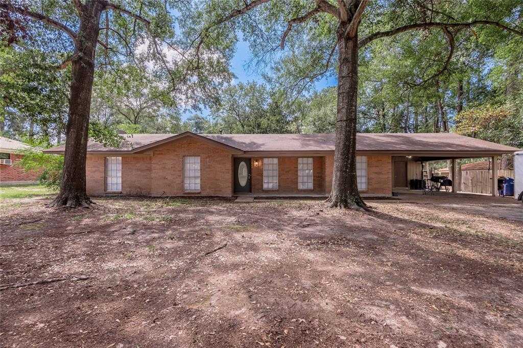 a view of a house with a yard and tree