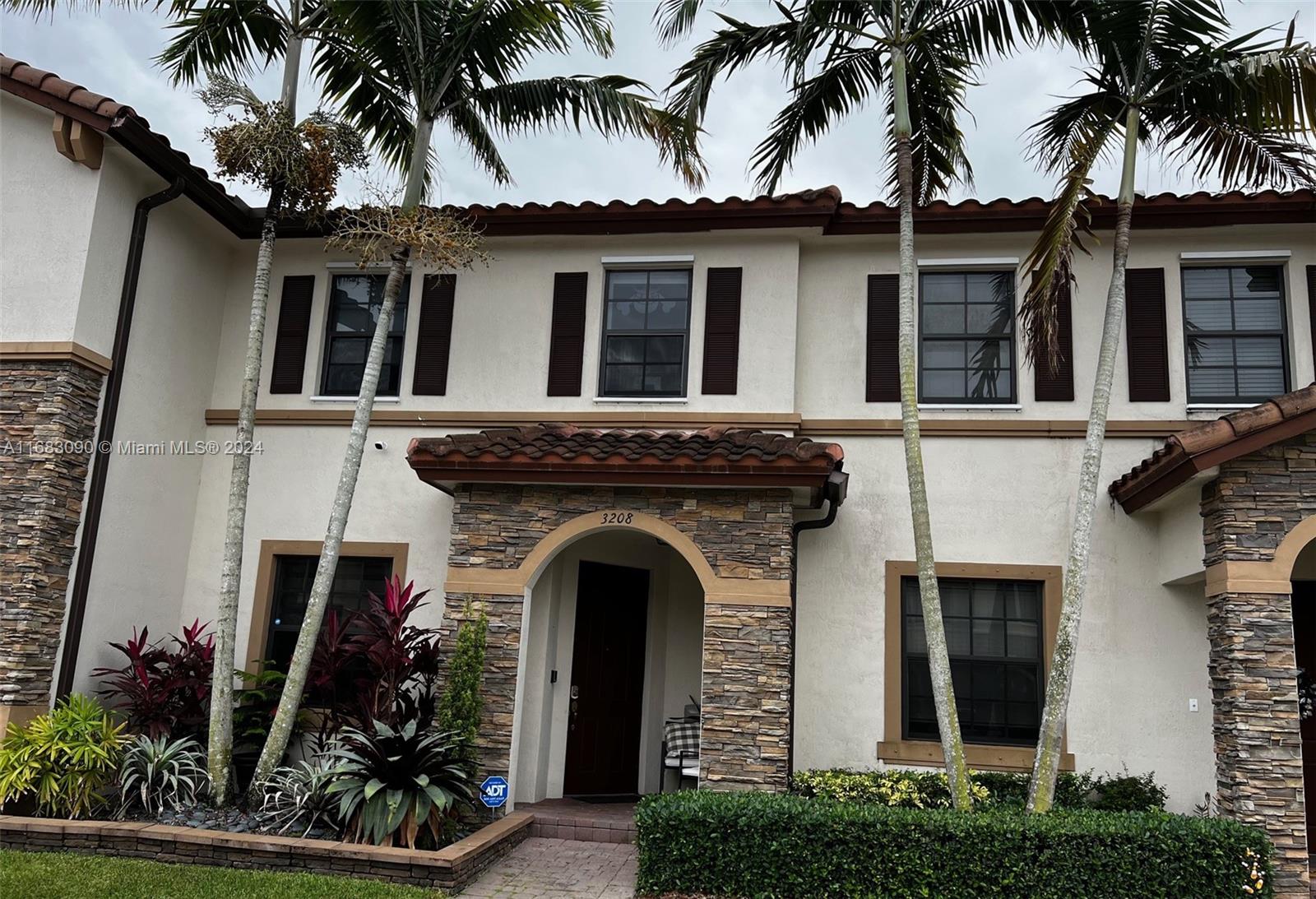 front view of a house with a potted plants