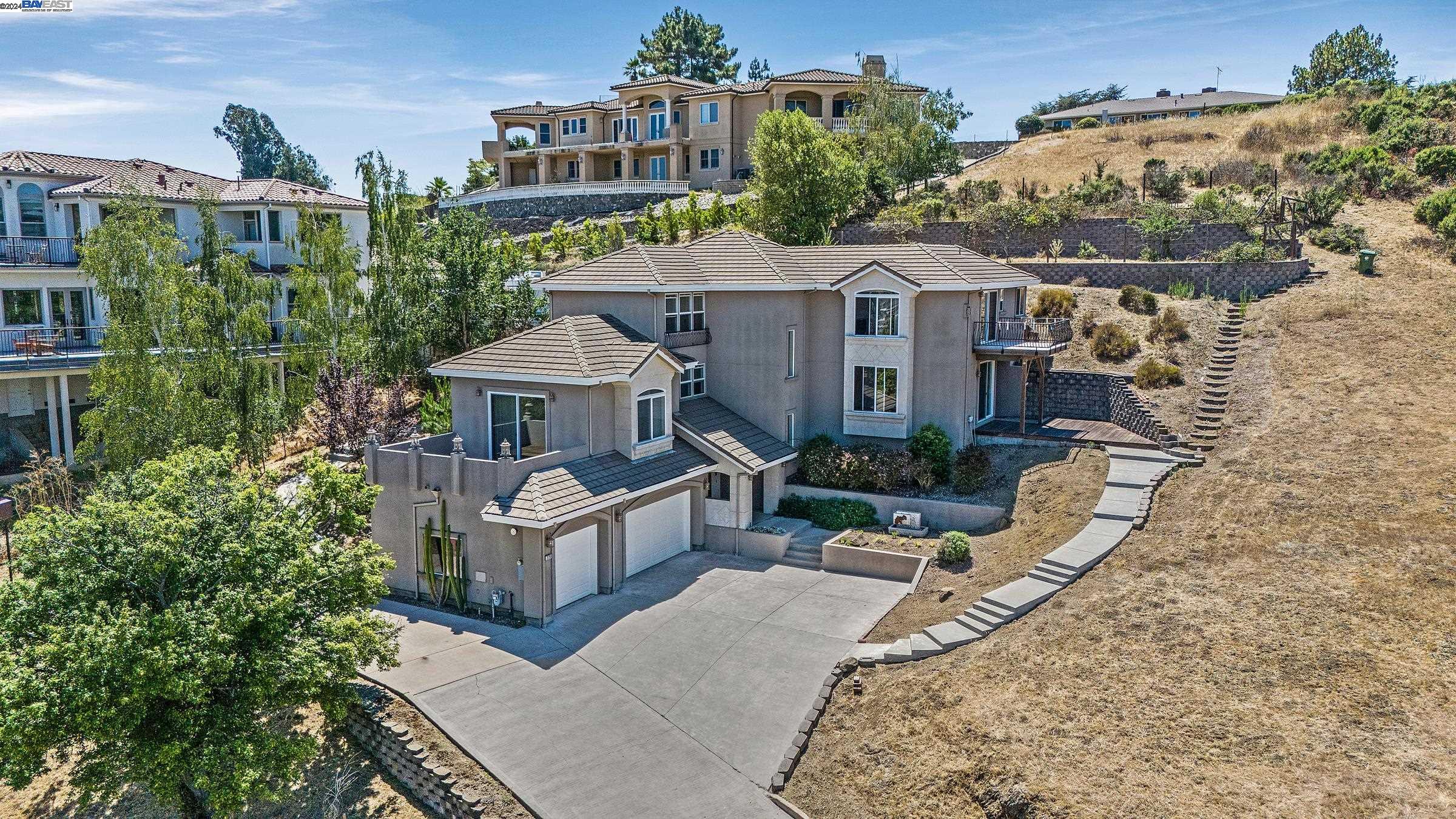 an aerial view of a house with a yard and potted plants