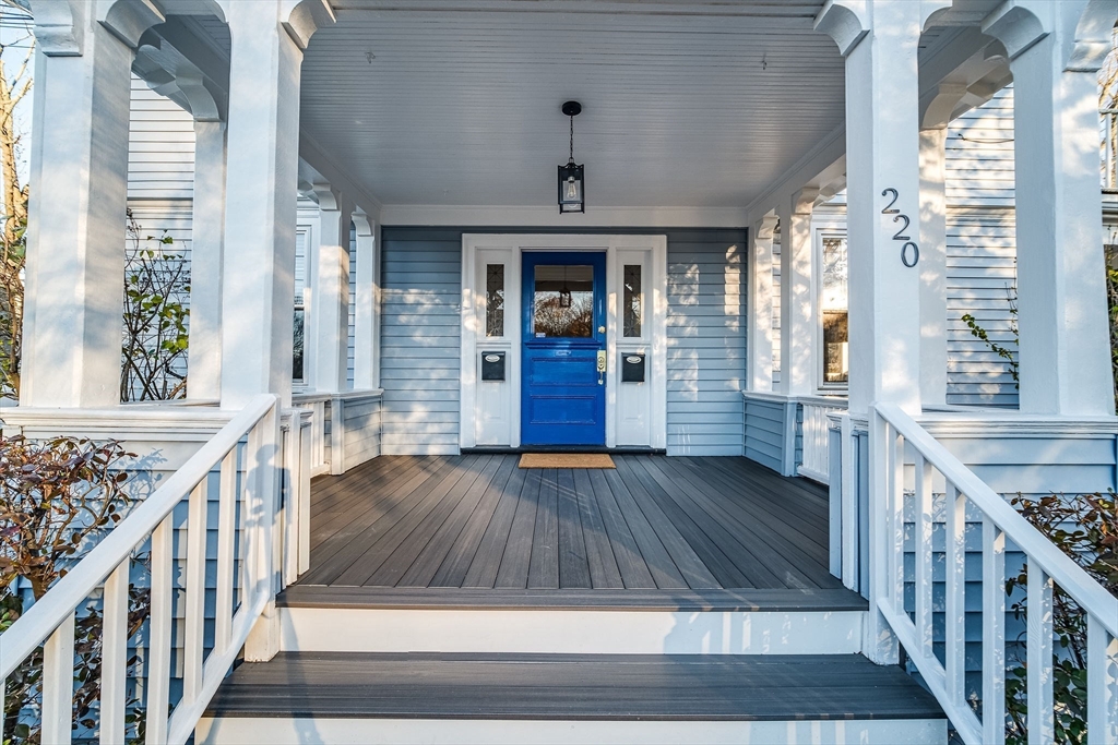 a view of an entryway with wooden floor and windows