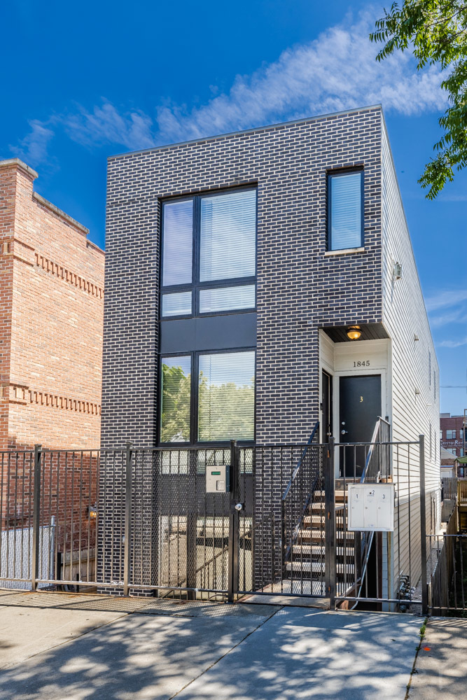 a front view of a house with a glass windows