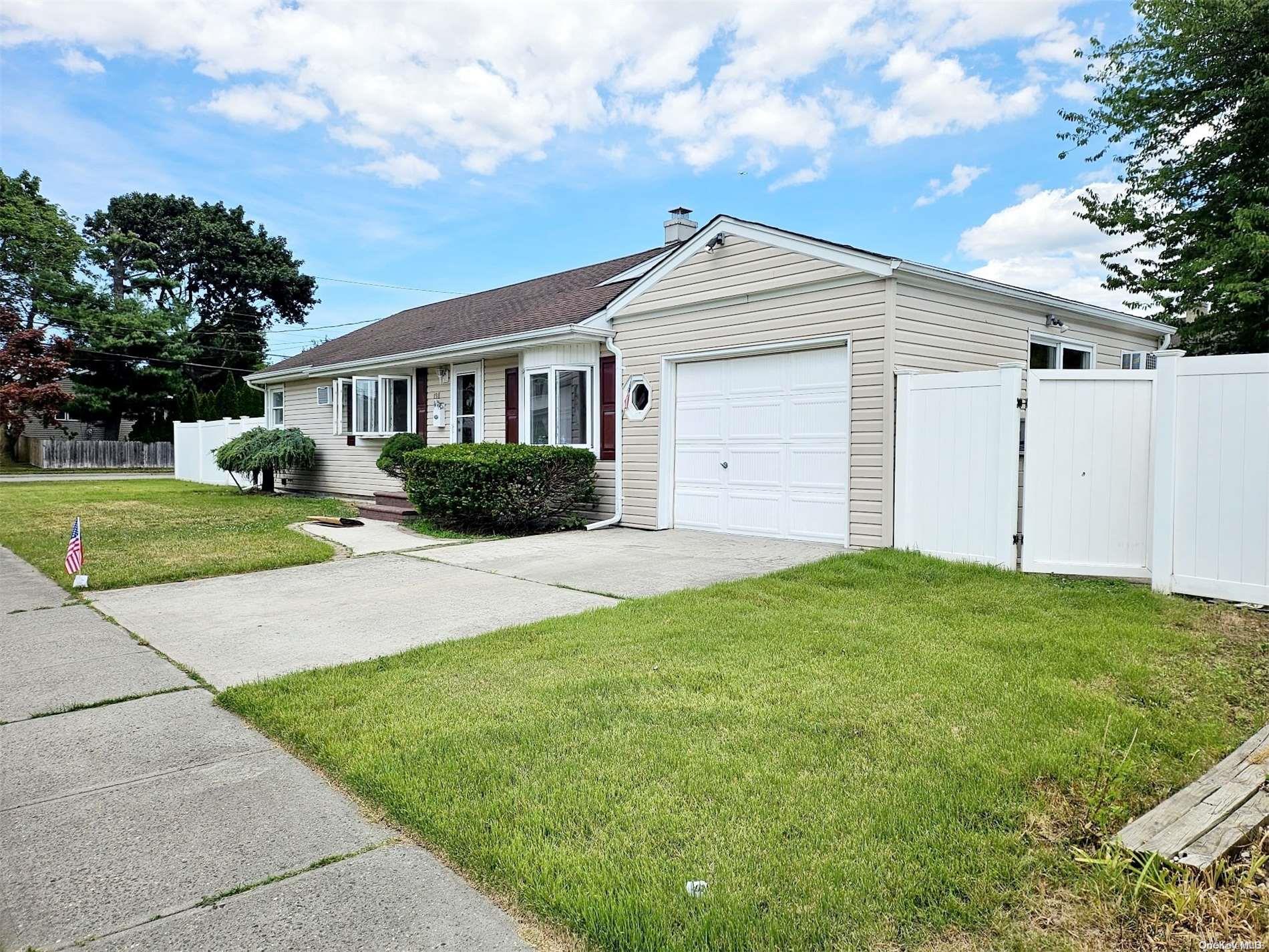 a view of a yard in front of a house with garage