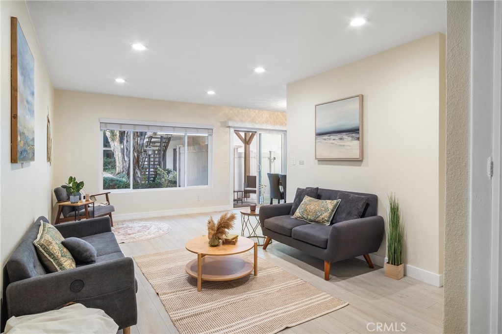 a living room with furniture and a potted plant