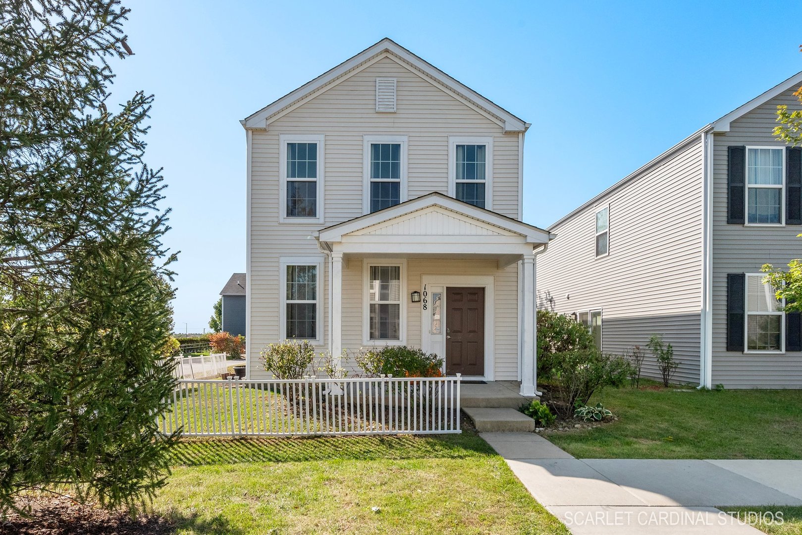 a front view of house with yard and green space