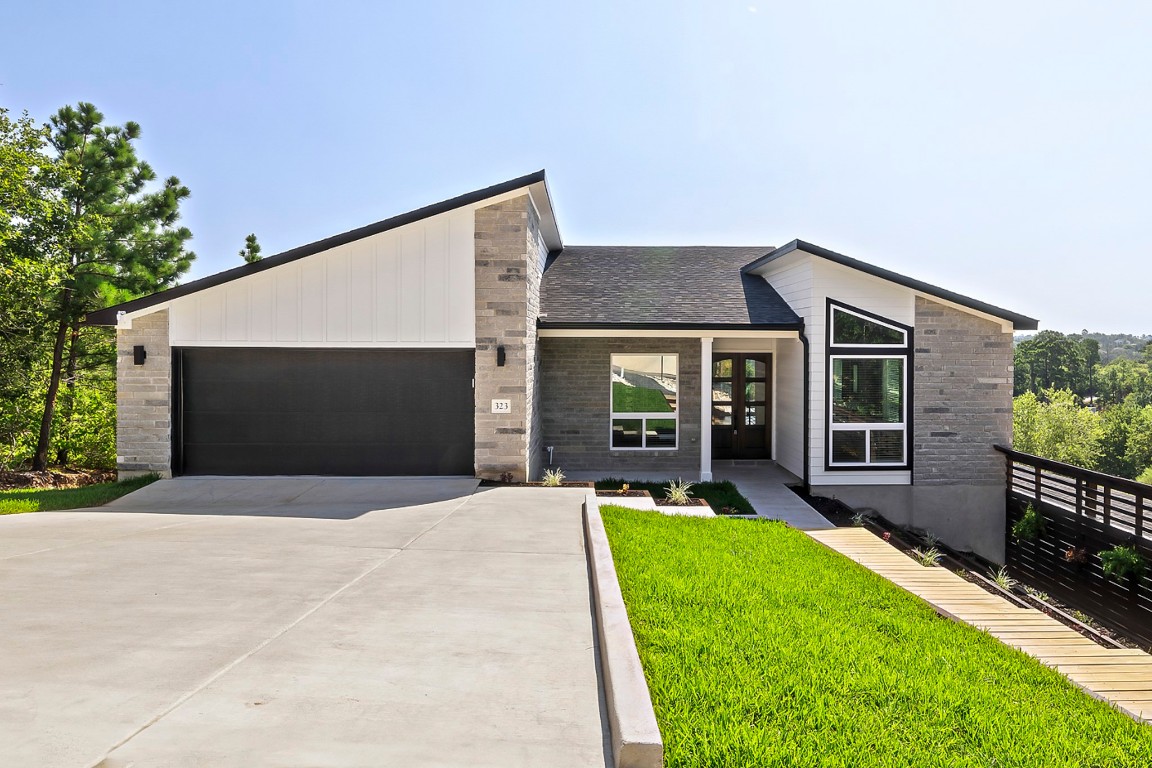 a front view of house with yard and green space