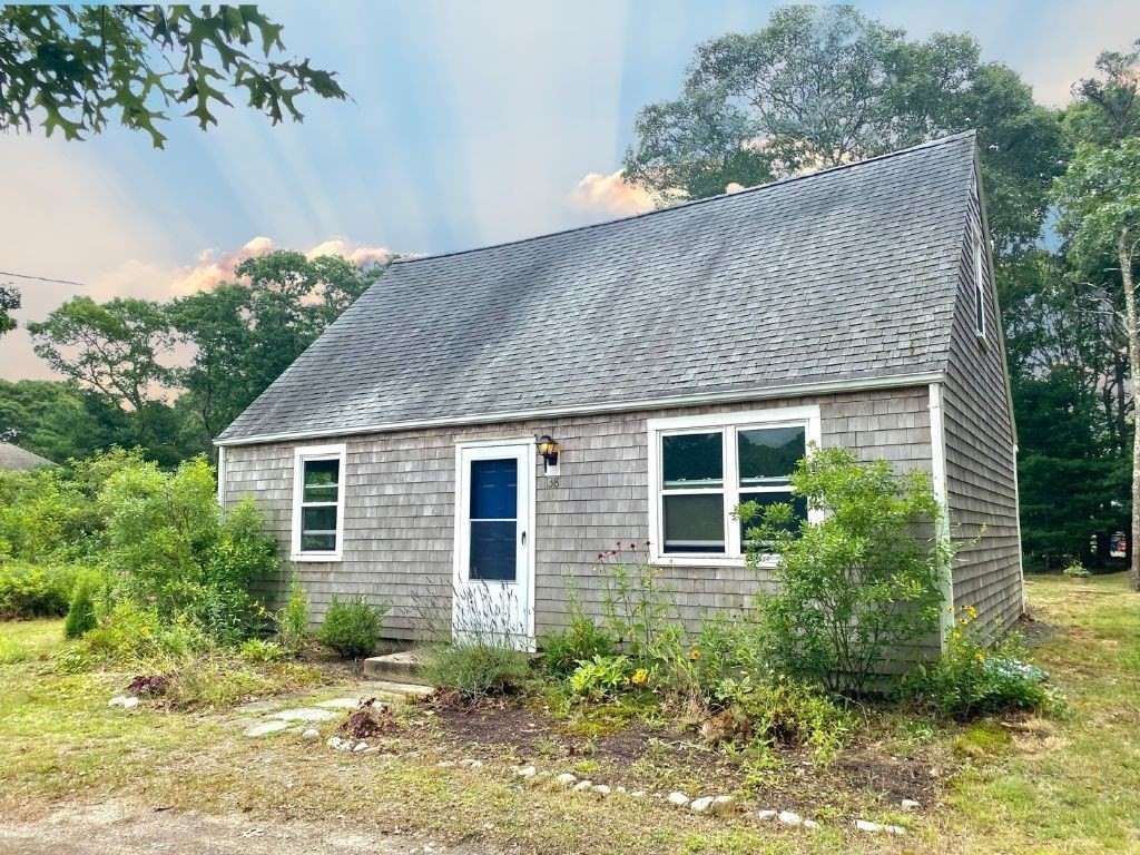 a view of house with yard