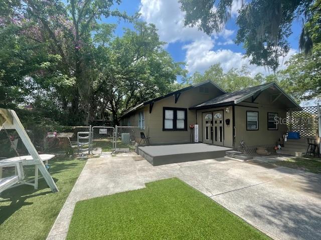 a backyard of a house with table and chairs