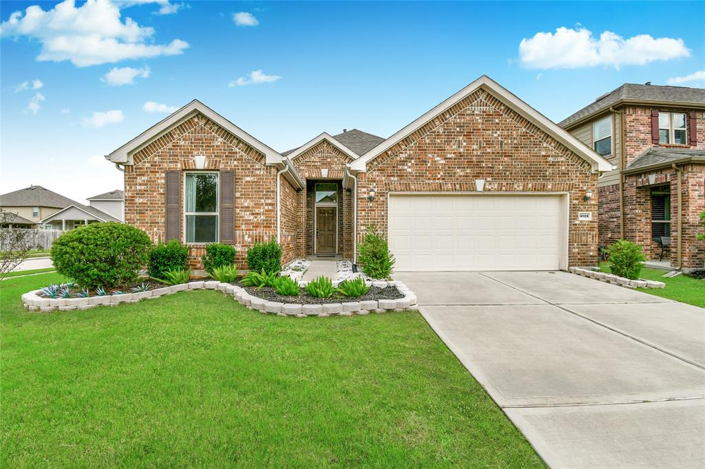 a front view of a house with a yard and garage