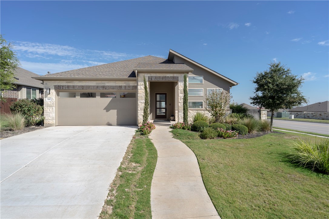 a front view of a house with garden