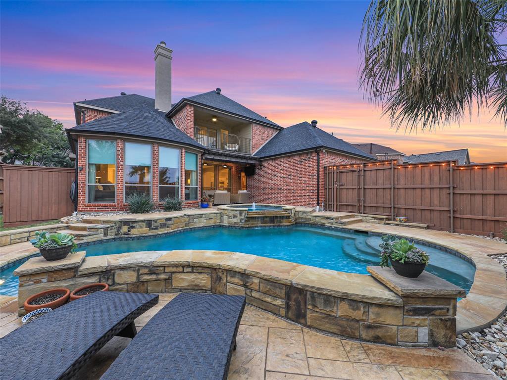 a front view of a house with swimming pool having outdoor seating