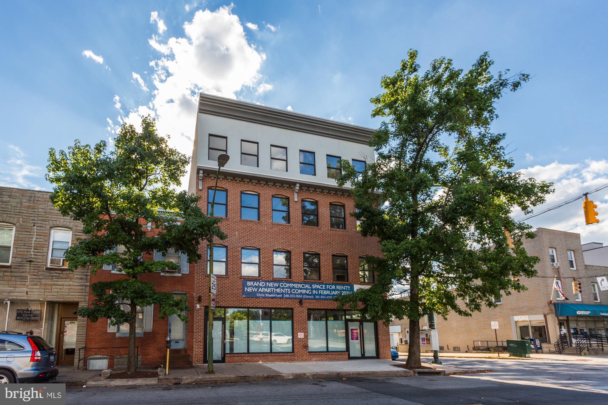 a front view of a building and trees