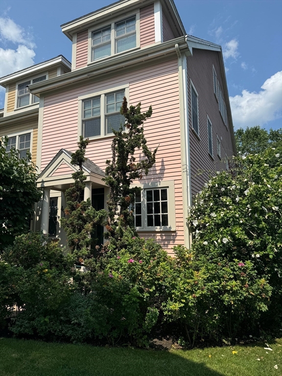 a yellow house with trees in front of it