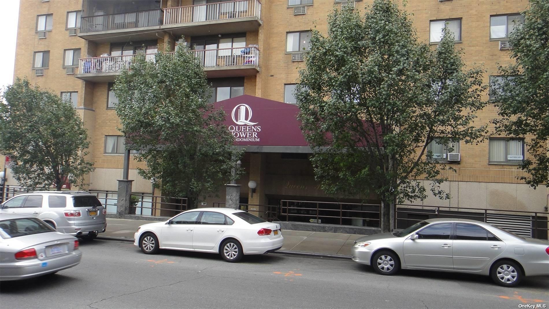 a view of a cars park in front of a building