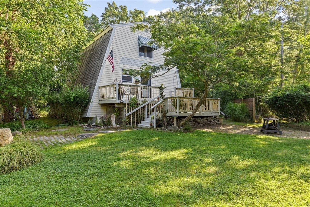 a view of a house with a yard and sitting area