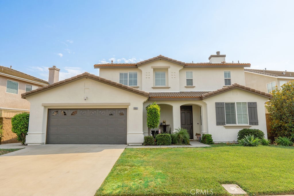 a front view of a house with a yard and garage