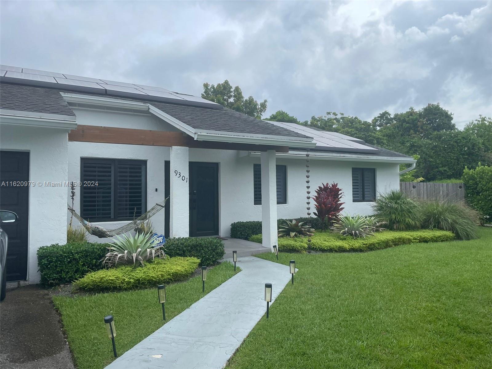 a front view of a house with garden