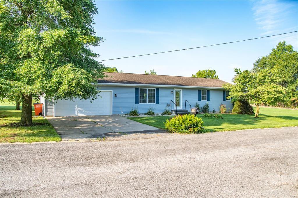 a front view of a house with a yard and a garage