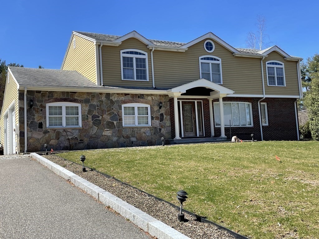 a front view of a house with a yard