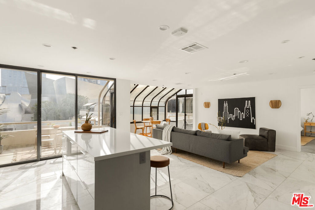 a living room with fireplace furniture and floor to ceiling window