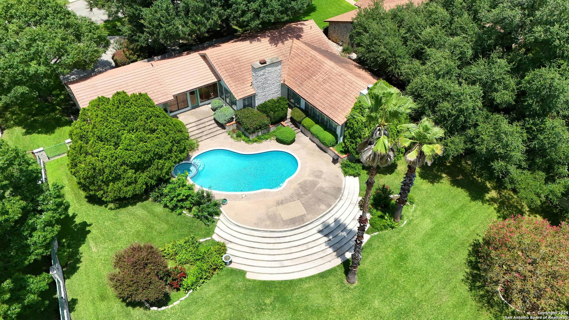 an aerial view of a house with outdoor space and street view