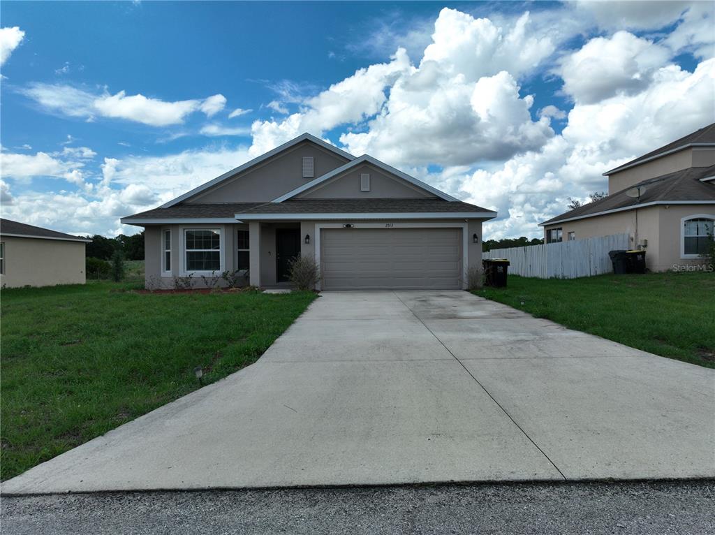 a front view of house with yard and green space