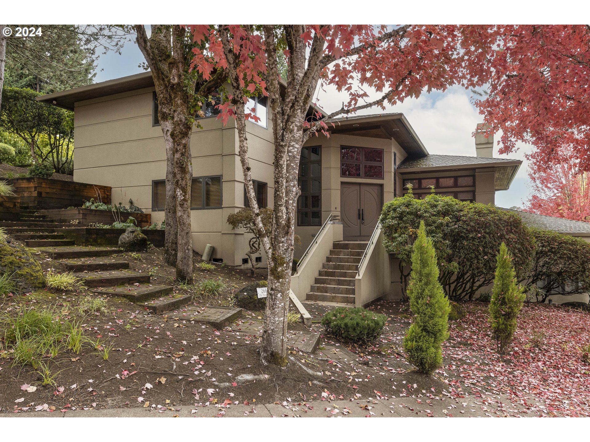 a view of a house with a yard and tree s