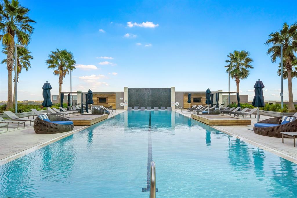 a view of swimming pool with outdoor seating