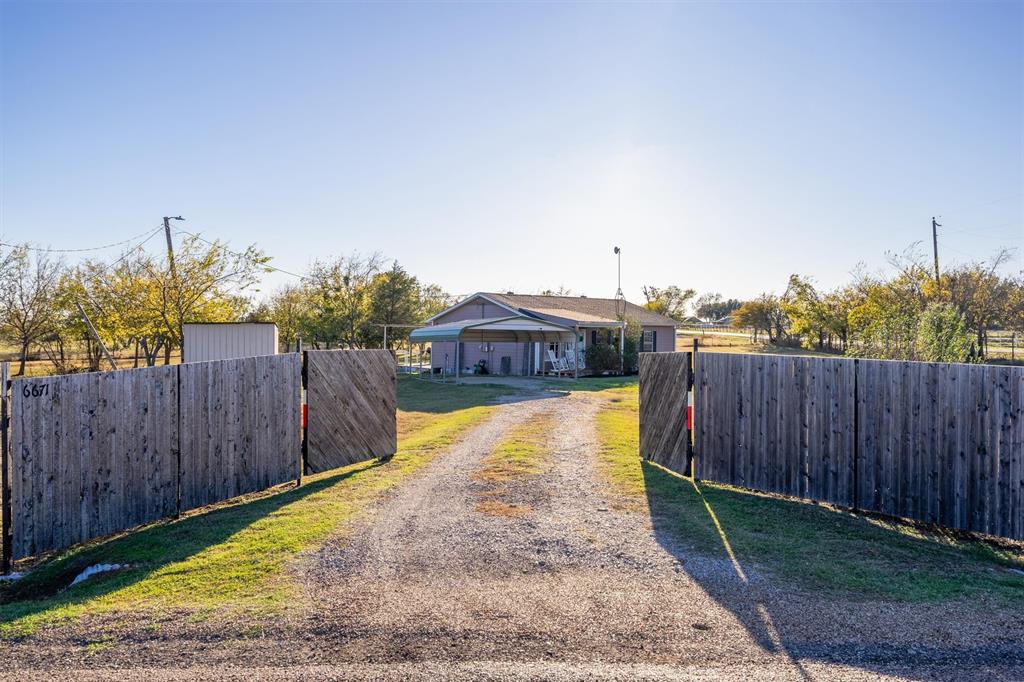 a view of a swimming pool with wooden fence