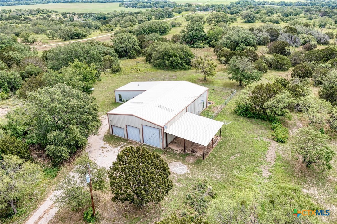 an aerial view of a house with a yard