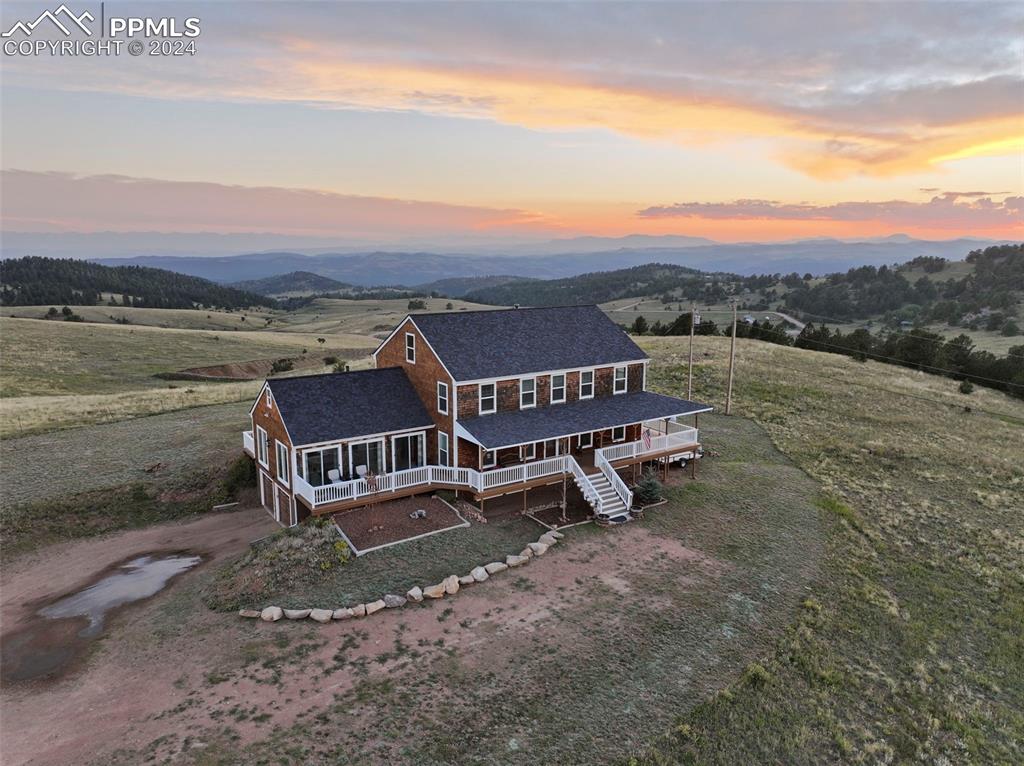 an aerial view of a house with a yard and lake view